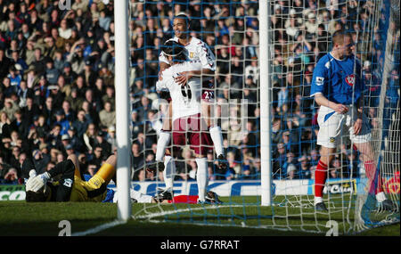 Soccer - FA Barclays Premiership - Portsmouth v Aston Villa - Fratton Park. Aston Villa's Luke Moore (centre top) celebrates with team-mate Juan Pablo Angel after an own goal by Portsmouth's Arjan De Zeeuw Stock Photo