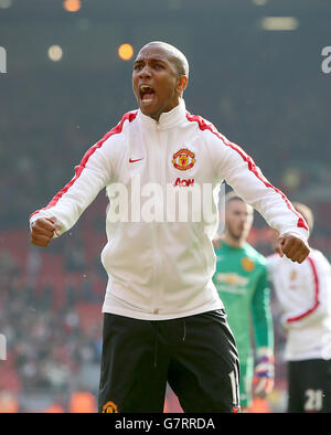 Manchester United's Ashley Young celebrates after the final whistle during the Barclays Premier League match at Anfield, Liverpool. Stock Photo
