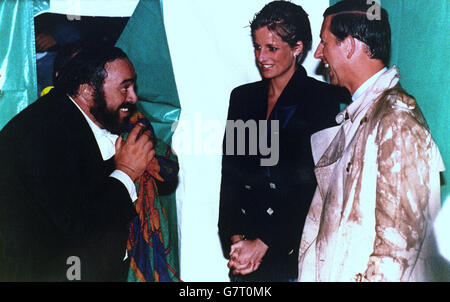 A rain-soaked Prince and Princess of Wales chat to Luciano Pavarotti after his concert in Hyde Park in London. *UK Provs Use Only, All TV and Nationals (Including Regional Editions) Out. Stock Photo