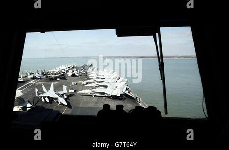 Planes parked on the flight deck of the US aircraft carrier USS Theodore Roosevelt, currently at anchor off the UK's south coast as it is too big to enter one of the Royal Navy's major bases, the carrier, one of ten Nimitz class aircraft carriers in the US fleet, arrived at Portsmouth, Hampshire, yesterday for a five-day visit. Stock Photo