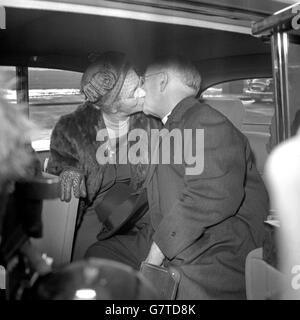 Dr. Geoffrey Fisher, the Archbishop of Canterbury, gives his wife a farewell kiss before leaving a car at London Airport to board a plane for Beirut on the first stage of a pilgrimage to the Holy Land, Istanbul and Rome, where he is to meet the Pope. Stock Photo