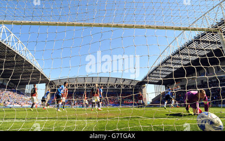 Brighton and Hove Albion's keeper David Stockdale looks on as Wigan Athletic's Tim Chow celebrates scoring their first goal Stock Photo