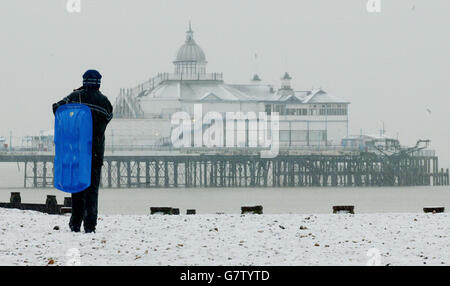 Kane Trayers, 13, finishes an afternoon of sledging on Eastbourne beach. Stock Photo