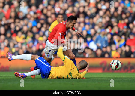 Chile's Alexis Sanchez is brought down by Brazil's Miranda during the International Friendly at the Emirates Stadium, London. Stock Photo