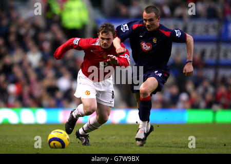 Soccer - FA Barclays Premiership - Manchester United v Portsmouth - Old Trafford. Manchester United's Wayne Rooney and Portsmouth's Matthew Taylor Stock Photo