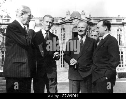 An after lunch cigar is enjoyed in the gardens of the Matignon, the official residence of the French Premier, during the visit to Paris by Prime Minister Harold MacMillan (far left) and Foreign Secretary Selwyn Lloyd (second from right). Entertaining them are the French Premier Michel Debre (far right) and Foreign Minister Couve De Murville. Stock Photo