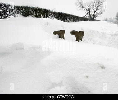 A man struggles in deep snow as bad weather persists across the county. Heavy snow fell across parts of Britain overnight as the country's cold snap entered its most bitter phase. Stock Photo