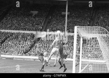 Sutton United's M Mellows in a duel with North Shields' goalkeeper during the FA Amateur Cup final. Stock Photo