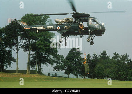A man being winched into a helicopter at the Britannia Royal Naval College, Dartmouth. This will be one set of training that the Prince of Wales will receive during his six-week course starting in September. Stock Photo