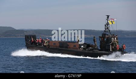 Relatives of veterans of the Gallipoli Campaign wave from an amphibious landing craft as they approach the shore of Eceabat, Turkey, during commemorations marking the 100th anniversary of one of Britain's worst military disasters. Stock Photo