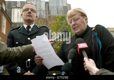 Surrey Police Assistant Chief Constable Mark Rowley listens as a statement is read following the conviction of two of his former officers on charges of misuse of their public office. Andrew Lang and Mark Witcher were sentenced to 15 months. The pair were found not guilty however of raping a victim of crime after taking her home. Mr Rowley and the complaiant's counsellor both read statements although the counsellor (right) requested not to be named. Stock Photo