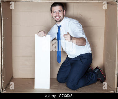 businessman in the small office pointing Stock Photo