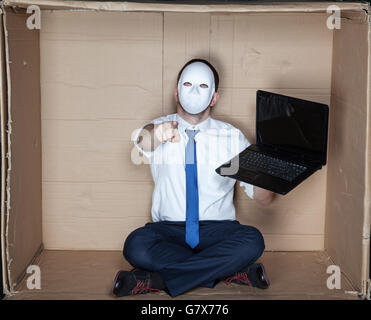 hacker in mask pointing at you Stock Photo