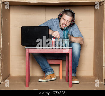 student puts out a cigarette in a glass with alcohol Stock Photo