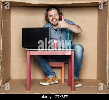 Unemployed student sitting in his room playing video games Stock Photo