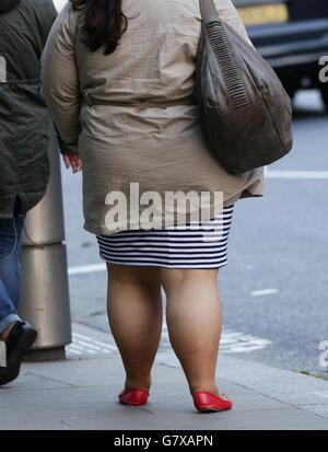 Detail of a woman walking along Kensington High Street in West London. Stock Photo