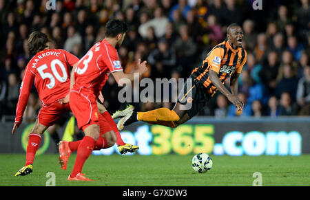 Hull City's Dame N'Doye battles for the ball with Liverpool's Lazar Markovic, during the Barclays Premier League match at the KC Stadium, Hull. Stock Photo