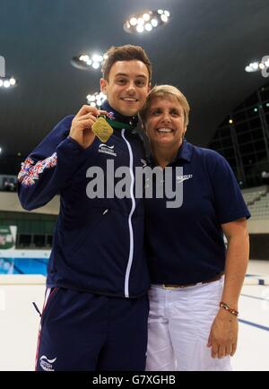 Great Britain's Tom Daley holds his gold medal after winning the men's 10m platform final alongside his coach Jane Figueiredo during the FINA Diving World Series at London Aquatics Centre. Stock Photo