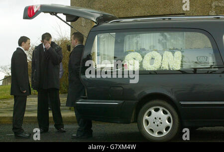 Andrew Morton (centre), father of two-year-old Andrew Morton, holds his head before he takes the coffin it into St Dominic's church. Stock Photo