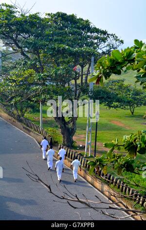 Five men walking along a road in Galle Sri Lanka Stock Photo