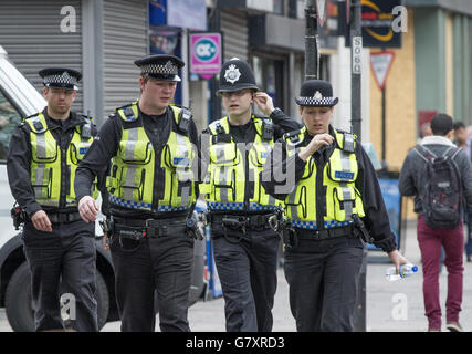 Four British Transport Police officers patrol the street in Highbury, London. Stock Photo