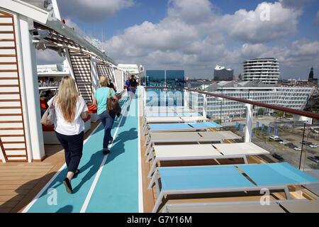 Hamburg, Germany. 27th June, 2016. The sun shines as guests walk along the pool deck of the 'Mein Schiff 5' cruise ship, pictured at Hamburg, Germany, 27 June 2016. The Tui Cruises ship will be christened on 15.07.2016 in Luebeck-Travemuende, Germany. PHOTO: BODO MARKS/DPA/Alamy Live News Stock Photo