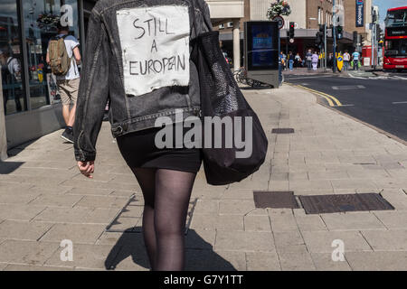 Kingston-upon-Thames, UK. 27th June, 2016. A young woman dressed in black denim and leggings has pinned a homemade sign on her back reading “Still A European” as she walks through Kingston-upon-Thames shopping centre Credit:  On Sight Photographic/Alamy Live News Stock Photo