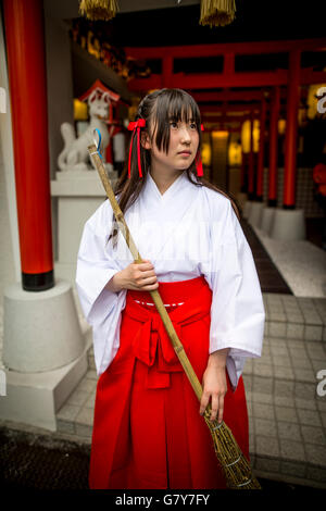 TOKYO, JAPAN - JUNE 27 : A shrine maiden posed for a portrait in front of the entrance of Akihabara shrine in Akihabara, Tokyo, Japan. June 27, 2016. © Richard Atrero de Guzman/AFLO/Alamy Live News Stock Photo
