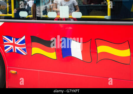 British, German, French and Spanish flags on a London tour bus, London, England Stock Photo