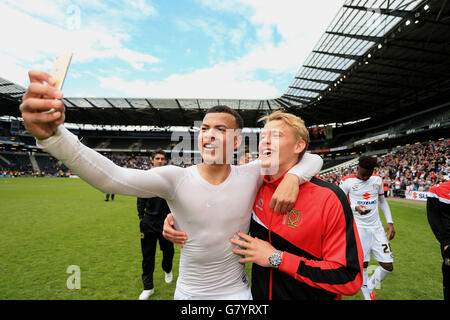 MK Dons' Dele Alli (left) and Tottenham Hotspurs' Tom Carroll