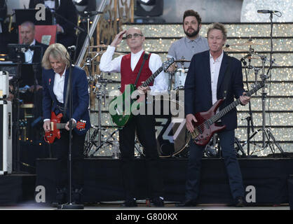 Rick Parfitt (left), Francis Rossi (centre) and John Edwards of Status Quo during the VE Day 70: A Party to Remember concert on Horse Guards Parade, Whitehall, London. Stock Photo