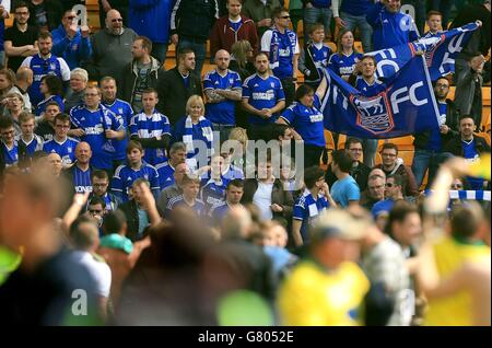 Ipswich Town fans look on as Norwich City fans celebrate on the pitch after the Sky Bet Championship Play Off, Second Leg, match at Carrow Road, Norwich. Stock Photo