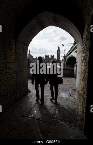 A general view of the houses of parliament looking across the River Thames though an archway underneath from one end of Westminster Bridge. Stock Photo