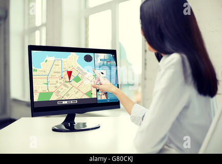 close up of woman with navigator map on computer Stock Photo