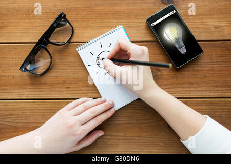 close up of woman or student writing to notepad Stock Photo