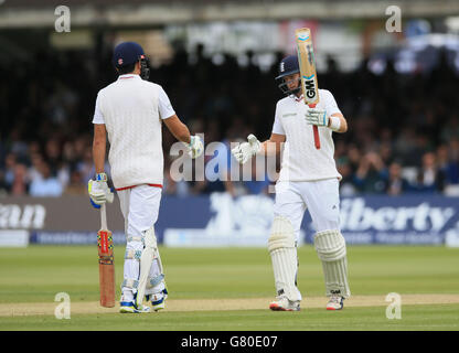 England's Joe Root reaches his half century and is congratulated by Alastair Cook during their innings against New Zealand's during day four of the first Investec Test Match at Lord's, London. Stock Photo