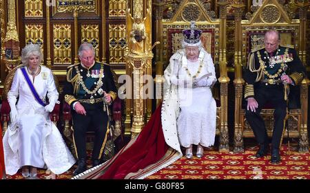Queen Elizabeth II delivers the Queen's Speech from the throne in the House of Lords next to the Duke of Edinburgh, the Prince of Wales (second left) and the Duchess of Cornwall during the State Opening of Parliament at the Palace of Westminster in London. Stock Photo