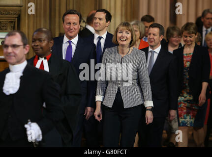 Prime Minister David Cameron (left) walks with acting leader of the Labour Party Harriet Harman (front right), followed by Chancellor of the Exchequer George Osborne (centre left) and Shadow chancellor Chris Leslie (centre right) followed by Home Secretary Theresa May (left) and Labour leadership contender Yvette Cooper , as they process with fellow members through the central lobby during the State Opening of Parliament at the Palace of Westminster in London. Stock Photo