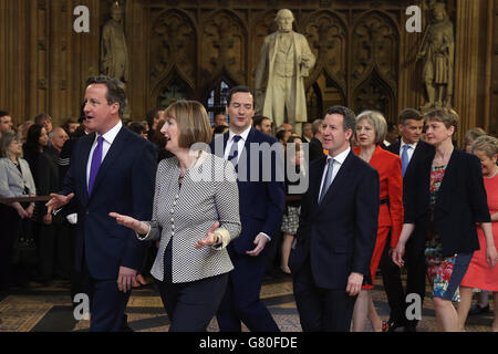 Prime Minister David Cameron (left) walks with acting leader of the Labour Party Harriet Harman (front right), followed by Chancellor of the Exchequer George Osborne (centre left) and Shadow chancellor Chris Leslie (centre right) followed by Home Secretary Theresa May (left) and Labour leadership contender Yvette Cooper , as they process with fellow members through the central lobby during the State Opening of Parliament at the Palace of Westminster in London. Stock Photo