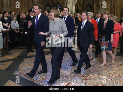 Prime Minister David Cameron (left) walks with acting leader of the Labour Party Harriet Harman (front right), followed by Chancellor of the Exchequer George Osborne (centre left) and Shadow chancellor Chris Leslie (centre right) followed by Home Secretary Theresa May (left) and Labour leadership contender Yvette Cooper , as they process with fellow members through the central lobby during the State Opening of Parliament at the Palace of Westminster in London. Stock Photo