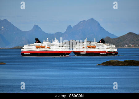 Nordlys and Nordnorge Hurtigruten ferries passing of Lofoten Islands, Arctic Norway Stock Photo