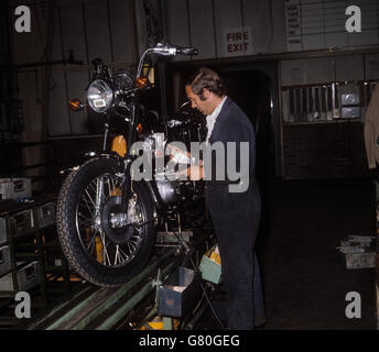 Barry Booth fitting the 750cc engine to a Bonneville motorcycle at Norton Villiers Triumph Motorcycle factory in Meridan, West Midlands. Stock Photo