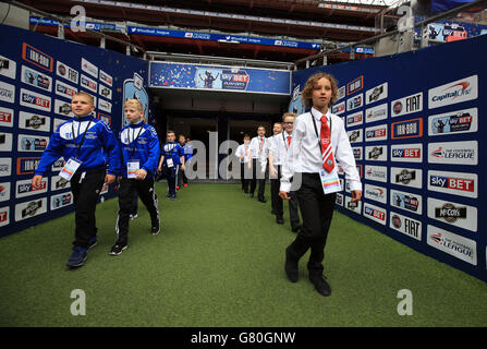 Oldham Athletic represented by South Failsworth Primary school (left) and Crawley Town represented by The Oaks Primary school walk out the tunnel prior to the Kinder+Sport Football League Kids Cup Final Stock Photo