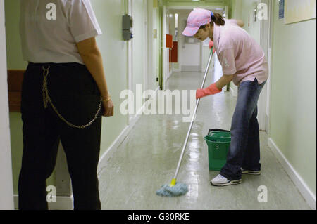 A prisoner in the young offenders unit of HMP Holloway mops floors. Anne Owers , the Chief Inspector of Prisons, announced the findings of her report into the north London jail. Stock Photo