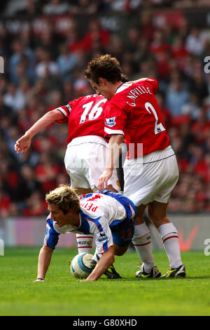 Soccer - FA Barclays Premiership - Manchester United v Blackburn Rovers - Old Trafford. Blackburn Rovers' Morten Gamst Pedersen battles for the ball with Manchester United's Roy Keane and Gary Neville Stock Photo