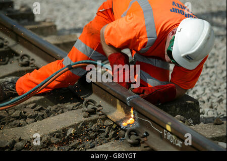 Cutting old rail at Bourne End as part of the West Coast Main Line upgrade. Stock Photo