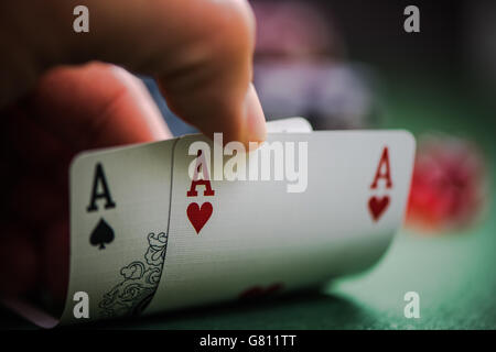 man shows two aces in poker game in casino Stock Photo