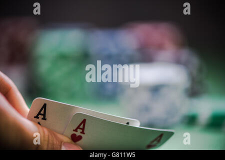 man shows two aces in poker game in casino Stock Photo