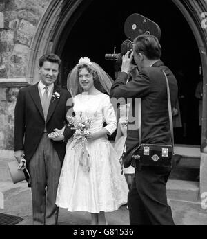 Richard Baker is filmed for TV as he leaves with his bride, formerly Margaret Martin, after their wedding at St Mary The Boltons church in Kensington, London. Stock Photo