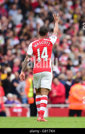 Arsenal's Theo Walcott celebrates scoring a hat trick during the Barclays Premier League match at the Emirates Stadium, London. Stock Photo